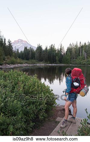 Young female hiker looking out to lake, Mount Hood National Forest, Oregon, USA View Large Photo Image Stock Photo - Young female hiker looking out to lake, Mount Hood National Forest, Oregon, USA. Fotosearch