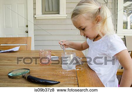 Young girl doing science experiment View Large Photo Image Stock Photo - Young girl doing science experiment. Fotosearch