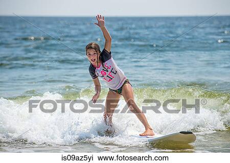 Young girl on surfboard in sea View Large Photo Image Stock Image - Young girl on surfboard in sea. Fotosearch