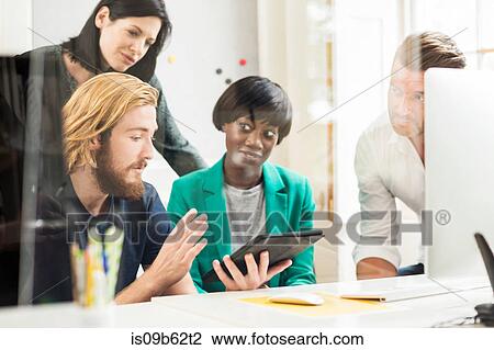 Young male designer explaining idea at team meeting in creative studio View Large Photo Image Stock Image - Young male designer explaining idea at team meeting in creative studio. Fotosearch