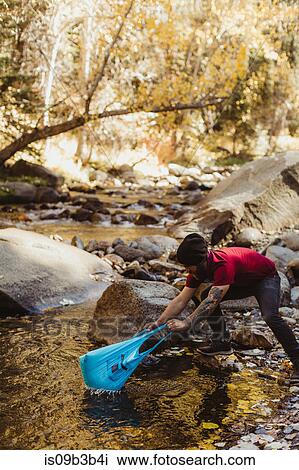 Young male hiker fishing with plastic bag in river, Mineral King, Sequoia National Park, California, USA View Large Photo Image Stock Image - Young male hiker fishing with plastic bag in river, Mineral King, Sequoia National Park, California, USA. Fotosearch