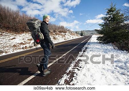 Young male hiker hiking on rural road in snow covered landscape, Ashland, Oregon, USA View Large Photo Image Stock Image - Young male hiker hiking on rural road in snow covered landscape, Ashland, Oregon, USA. Fotosearch