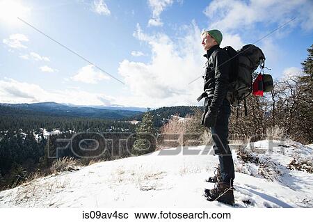 Young male hiker looking out from snow covered landscape, Ashland, Oregon, USA View Large Photo Image Stock Image - Young male hiker looking out from snow covered landscape, Ashland, Oregon, USA. Fotosearch