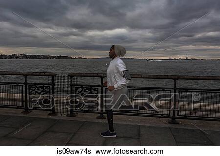 Young male runner running on riverside at dawn View Large Photo Image Stock Photograph - Young male runner running on riverside at dawn. Fotosearch