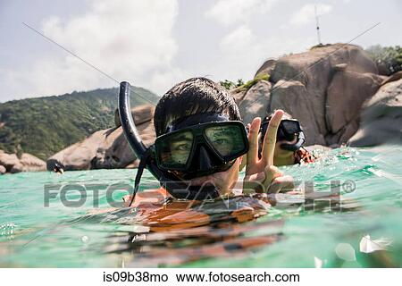 Young man and woman snorkelling, Nangyuan Island, Thailand View Large Photo Image Picture - Young man and woman snorkelling, Nangyuan Island, Thailand. Fotosearch