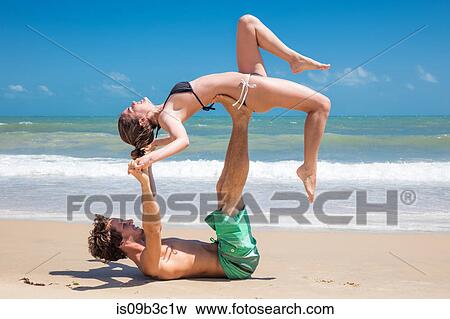 Young man balancing girlfriend above him on beach, Taiba, Ceara, Brazil View Large Photo Image Stock Photo - Young man balancing girlfriend above him on beach, Taiba, Ceara, Brazil. Fotosearch
