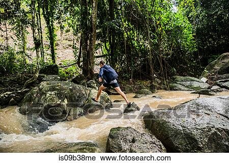 Young man crossing stream, Secret Buddha Garden, Koh Samui, Thailand View Large Photo Image Stock Image - Young man crossing stream, Secret Buddha Garden, Koh Samui, Thailand. Fotosearch