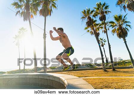 Picture - Young man exercising outdoors. Fotosearch