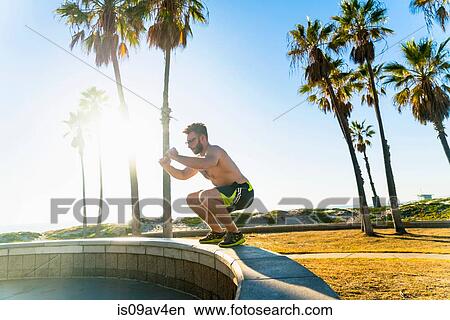 Picture - Young man exercising outdoors. Fotosearch