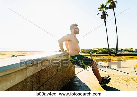 Young man exercising outdoors View Large Photo Image Stock Photography - Young man exercising outdoors. Fotosearch