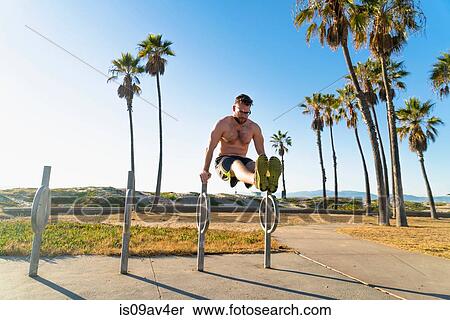 Young man exercising outdoors View Large Photo Image Stock Photography - Young man exercising outdoors. Fotosearch