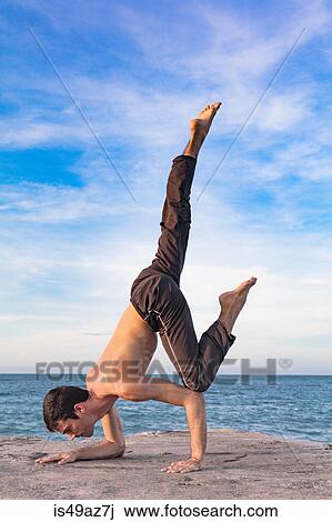 Young man outdoors, in yoga position, balancing on hand and forearm View Large Photo Image Stock Image - Young man outdoors, in yoga position, balancing on hand and forearm. Fotosearch