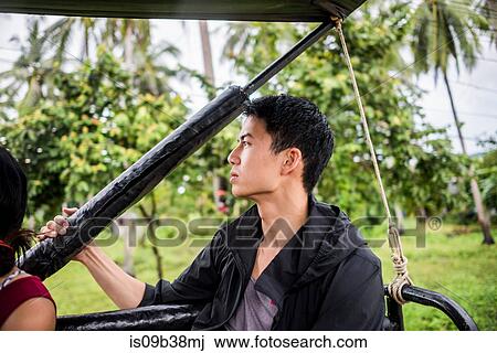 Young man sitting in back of jeep, Koh Samui, Thailand View Large Photo Image Stock Image - Young man sitting in back of jeep, Koh Samui, Thailand. Fotosearch