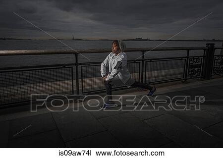 Young man training on riverside at dawn View Large Photo Image Stock Image - Young man training on riverside at dawn. Fotosearch