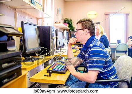Young man with down syndrome, learning at computer View Large Photo Image Picture - Young man with down syndrome, learning at computer. Fotosearch