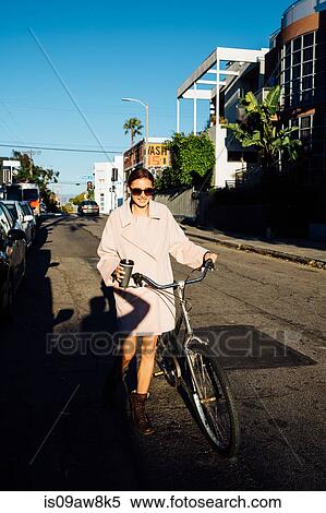 Young stylish woman pushing cycle along street, Venice Beach, California, USA View Large Photo Image Stock Photography - Young stylish woman pushing cycle along street, Venice Beach, California, USA. Fotosearch