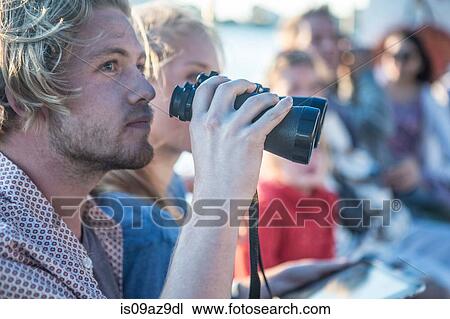 Young tourist couple with binoculars on boat trip, Cape Town, South Africa View Large Photo Image Stock Image - Young tourist couple with binoculars on boat trip, Cape Town, South Africa. Fotosearch