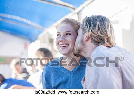 Stock Image - Young tourist man kissing girlfriend on boat trip, Cape Town, South Africa. Fotosearch