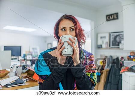 Young woman at home, drinking hot drink View Large Photo Image Stock Image - Young woman at home, drinking hot drink. Fotosearch