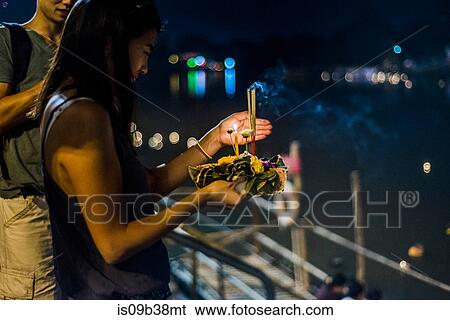 Young woman by Ping River in Chiang Mai during Loy Krathong Lantern Festival, releasing floating lantern down the Ping River, Chiang Mai, Thailand View Large Photo Image Stock Photograph - Young woman by Ping River in Chiang Mai during Loy Krathong Lantern Festival, releasing floating lantern down the Ping River, Chiang Mai, Thailand. Fotosearch