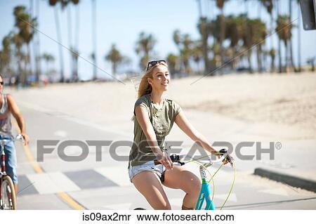 Young woman cycling at Venice Beach, Los Angeles, California, USA View Large Photo Image Stock Photography - Young woman cycling at Venice Beach, Los Angeles, California, USA. Fotosearch