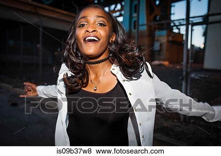 Young woman dancing in street, smiling View Large Photo Image Stock Photo - Young woman dancing in street, smiling. Fotosearch