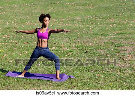 Young woman doing yoga in park View Large Photo Image Stock Image - Young woman doing yoga in park. Fotosearch