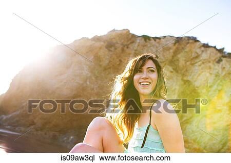Stock Image - Young woman enjoying beach. Fotosearch