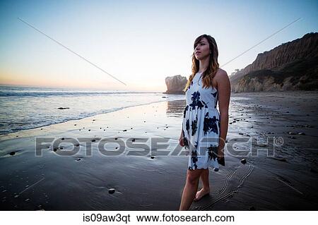 Stock Photograph - Young woman enjoying beach. Fotosearch