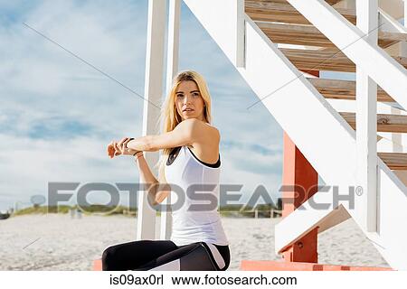 Young woman exercising on beach View Large Photo Image Stock Image - Young woman exercising on beach. Fotosearch