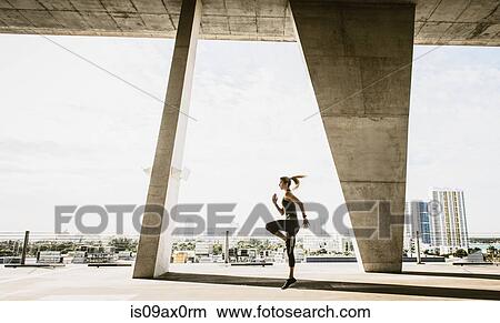 Young woman exercising under bridge View Large Photo Image Picture - Young woman exercising under bridge. Fotosearch