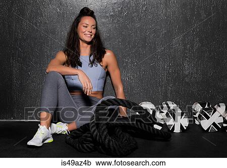 Young woman in cross fit gym, taking a break from workout View Large Photo Image Stock Image - Young woman in cross fit gym, taking a break from workout. Fotosearch
