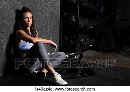 Young woman in cross fit gym, taking a break from workout View Large Photo Image Stock Image - Young woman in cross fit gym, taking a break from workout. Fotosearch