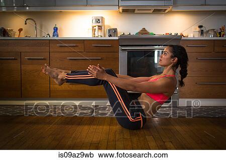 Young woman in kitchen, in yoga position View Large Photo Image Stock Image - Young woman in kitchen, in yoga position. Fotosearch