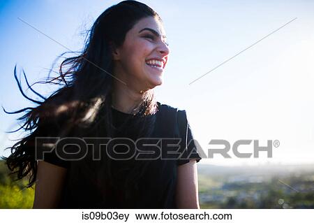 Young woman in rural setting, laughing View Large Photo Image Stock Photo - Young woman in rural setting, laughing. Fotosearch