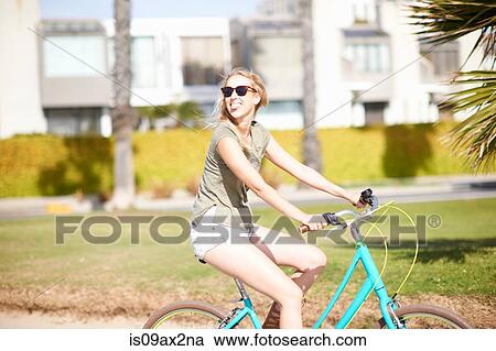 Young woman looking over her shoulder whilst cycling at Venice Beach, Los Angeles, California, USA View Large Photo Image Stock Image - Young woman looking over her shoulder whilst cycling at Venice Beach, Los Angeles, California, USA. Fotosearch