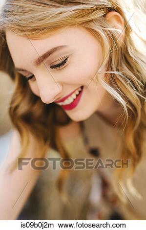 Young woman outdoors, smiling, close-up View Large Photo Image Picture - Young woman outdoors, smiling, close-up. Fotosearch