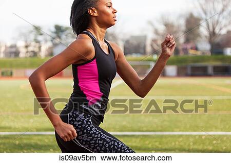 Young woman running on race track View Large Photo Image Picture - Young woman running on race track. Fotosearch