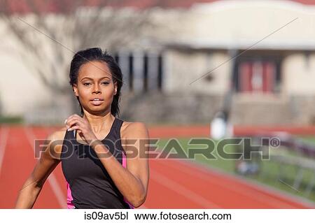 Young woman running on race track View Large Photo Image Stock Image - Young woman running on race track. Fotosearch