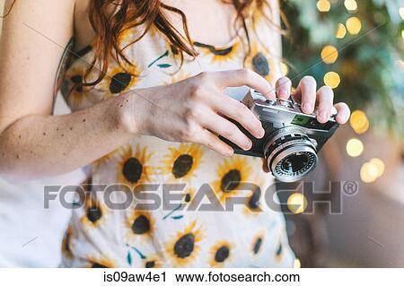 Young woman SLR camera, mid section View Large Photo Image Stock Image - Young woman SLR camera, mid section. Fotosearch