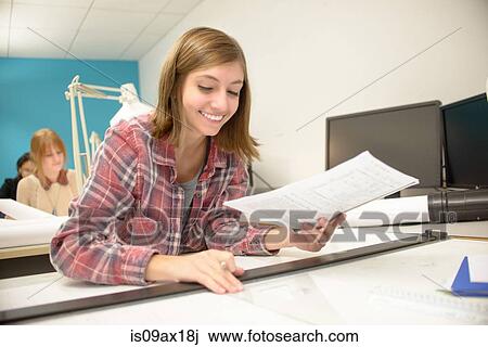 Stock Image - Young woman studying at community college. Fotosearch