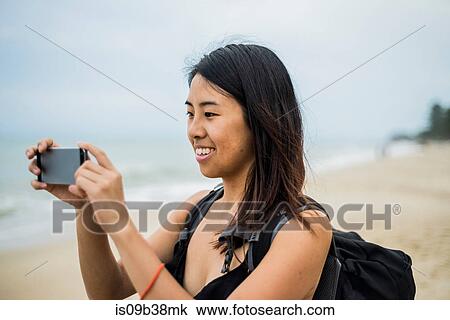 Young woman taking photograph at Lammai Beach, Koh Samui, Thailand View Large Photo Image Stock Image - Young woman taking photograph at Lammai Beach, Koh Samui, Thailand. Fotosearch
