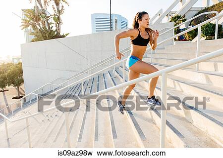 Young woman training, running up stairway at sport facility, downtown San Diego, California, USA View Large Photo Image Stock Photo - Young woman training, running up stairway at sport facility, downtown San Diego, California, USA. Fotosearch