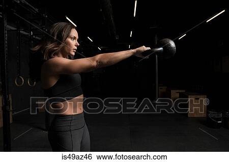 Young woman working out in cross fit gym View Large Photo Image Stock Photograph - Young woman working out in cross fit gym. Fotosearch