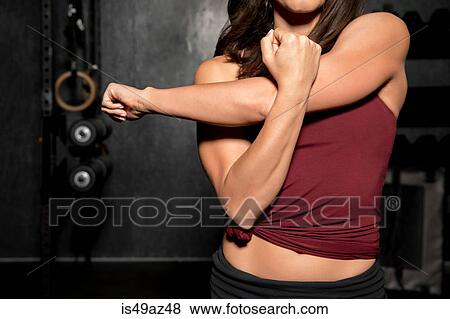Young woman working out in cross fit gym, mid section View Large Photo Image Stock Photo - Young woman working out in cross fit gym, mid section. Fotosearch