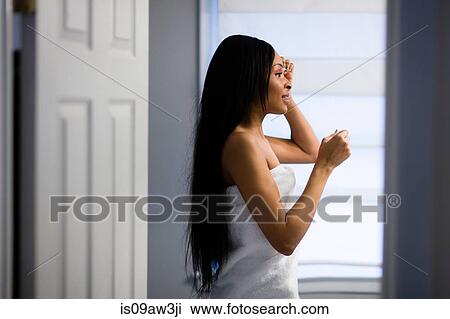 Young woman wrapped in white towel removing eye make up in bathroom View Large Photo Image Stock Image - Young woman wrapped in white towel removing eye make up in bathroom. Fotosearch