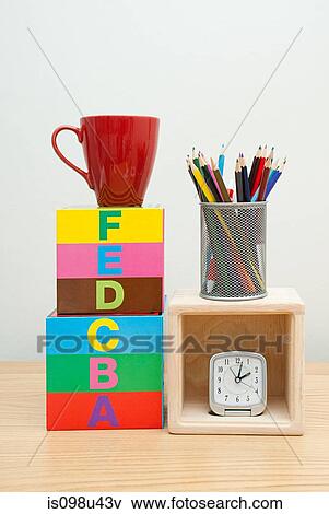 Stock Photo - Alphabet blocks, mug, pencils and clock. Fotosearch