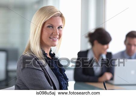 Businesswoman and colleagues on laptop View Large Photo Image Stock Image - Businesswoman and colleagues on laptop. Fotosearch
