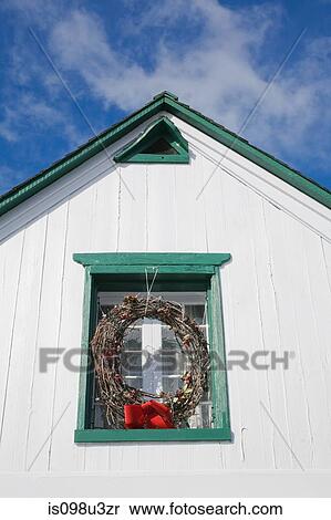 Stock Photography - Christmas wreath in window of building. Fotosearch