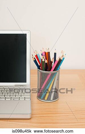 Stock Image - Colored pencils and laptop. Fotosearch